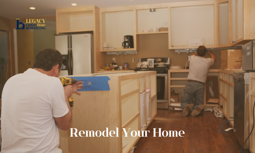 Two men are working in a kitchen under renovation with unpainted cabinets and tools. Text says "Remodel Your Home." The mood is busy and productive.
